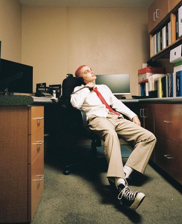 A desk with a phone, a calculator and unpaid invoices