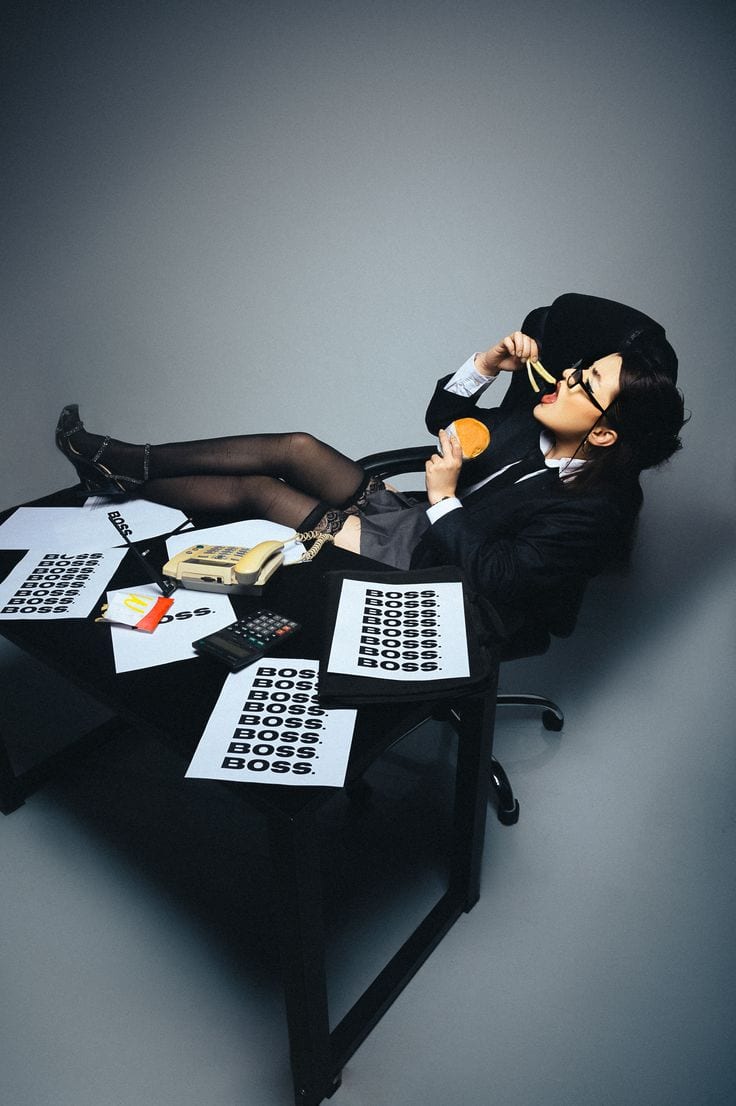 A desk with a phone, a calculator and unpaid invoices