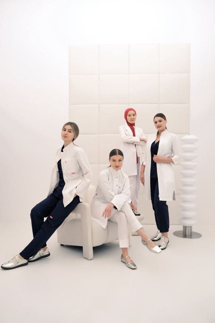 A professional team dressed in white in a bright space